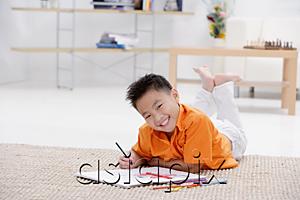 AsiaPix - Boy lying on floor with sketch pad, smiling at camera