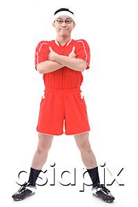 AsiaPix - Man in soccer uniform, arms crossed, smiling at camera