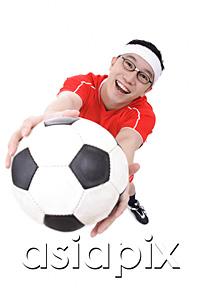 AsiaPix - Man holding soccer ball towards camera