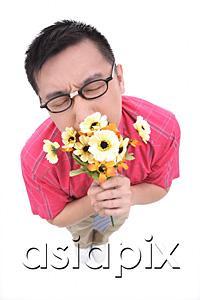 AsiaPix - Man smelling flower bouquet