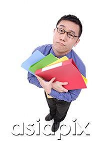 AsiaPix - Businessman carrying  multi coloured folders, sad expression