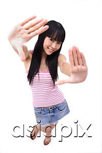 AsiaPix - Young woman with hands outstretched, smiling at camera
