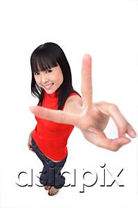 AsiaPix - Young woman making peace sign at camera
