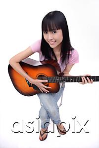 AsiaPix - Young woman with guitar, smiling at camera