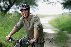 AsiaPix - Man on a bicycle, smiling at camera