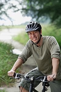 AsiaPix - Man on a bicycle, smiling at camera