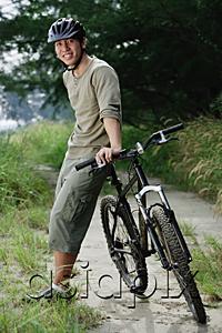 AsiaPix - Man standing next to bicycle