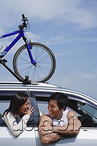 AsiaPix - Couple sitting in car, bicycle on the roof