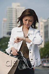 AsiaPix - Woman looking at watch