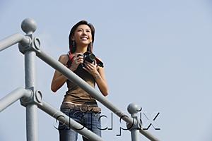 AsiaPix - Woman holding camera