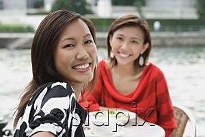 AsiaPix - Women at sidewalk cafe, smiling at camera
