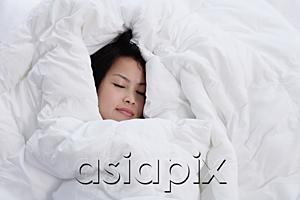 AsiaPix - Young woman sleeping, covered by blanket