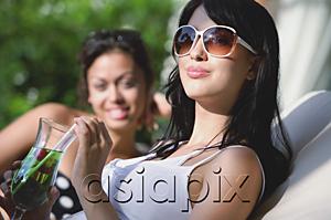 AsiaPix - Young women sitting on deck chairs