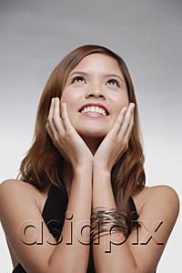 AsiaPix - Woman smiling, hands on face, looking up