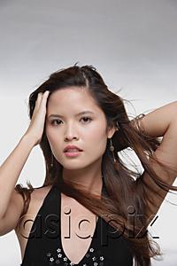 AsiaPix - Woman with wind blown hair, looking at camera