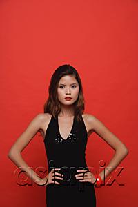 AsiaPix - Woman in black dress standing against red background