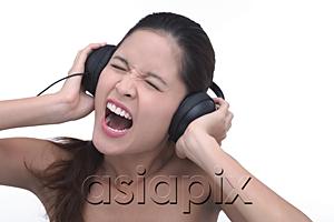 AsiaPix - Young woman wearing headphones, screaming