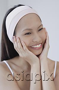 AsiaPix - Young woman with hands on face, smiling