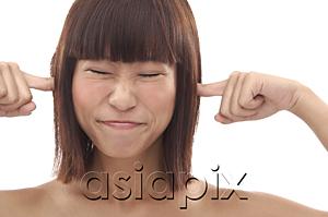 AsiaPix - Young woman sticking fingers into her ears