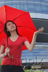 AsiaPix - Woman with red umbrella, looking up, frowning