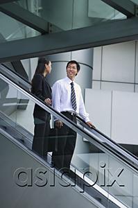 AsiaPix - Businessman and businesswoman on escalator