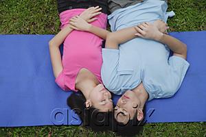 AsiaPix - Couple in park, lying on mat, eyes closed