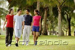 PictureIndia - Young adults walking in park, side by side