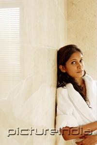 PictureIndia - Woman in bathrobe, leaning on wall, looking at camera, portrait