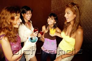 PictureIndia - Four women with drinks, standing and talking