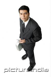 PictureIndia - Businessman, holding mobile phone and briefcase