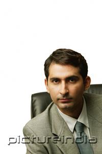 PictureIndia - Businessman sitting, looking at camera