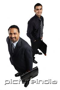 PictureIndia - Two businessmen with briefcases, smiling at camera