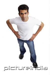 PictureIndia - Man looking at camera, hands on hip