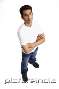 PictureIndia - Man looking at camera, arms crossed