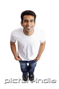 PictureIndia - Man smiling at camera, hands in pocket