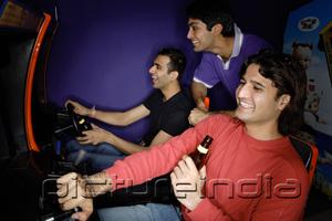 PictureIndia - Young men in amusement arcade