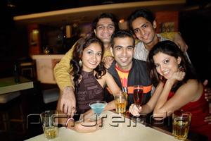 PictureIndia - Young adults in club, smiling at camera