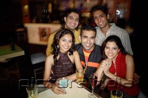 PictureIndia - Young adults in club, smiling at camera, portrait