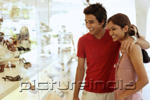 PictureIndia - Couple looking at window display of shoe shop