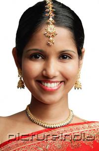 PictureIndia - Woman in traditional Indian attire smiling at camera