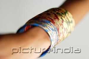 PictureIndia - Close-up of woman's arm with colourful bangles