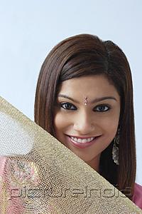 PictureIndia - Young woman smiling above veil