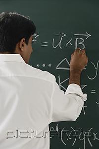 PictureIndia - teacher writing formulas on chalkboard