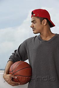 PictureIndia - young man with red cap, holding basketball