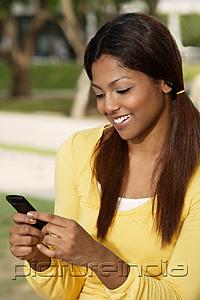 PictureIndia - woman looking at phone, smiling