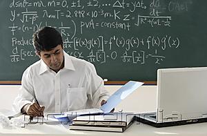 PictureIndia - teacher sitting at desk, working