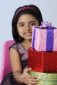 PictureIndia - Little girl holding gifts
