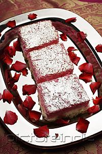PictureIndia - Indian pink sweets on silver tray with rose petals