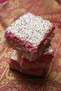 PictureIndia - A stack of Indian pink sweets with silver topping.