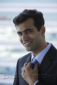 PictureIndia - Head shot of Indian businessman smiling.